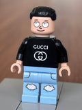 Gucci Morty minifigure wearing a black Gucci shirt and light blue pants